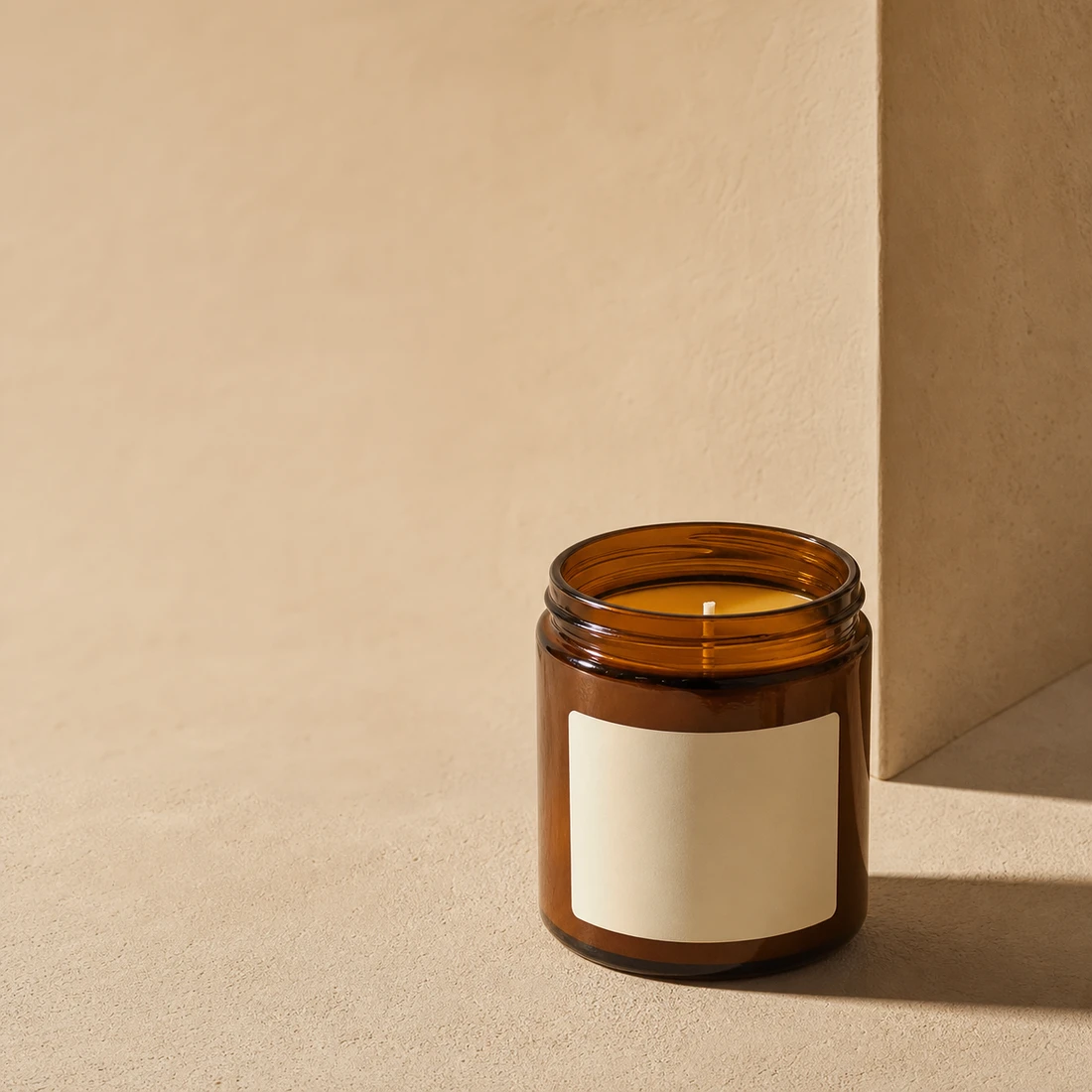 Amber candle jar presented in a warm campaign composition